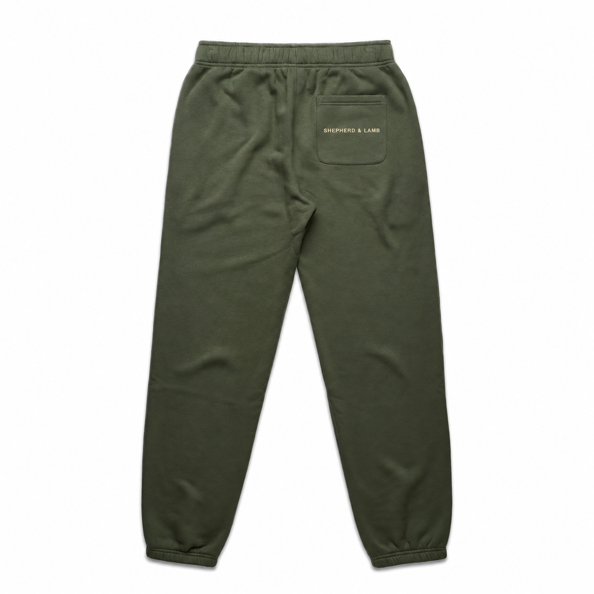Back view of the Shepherd & Lamb Signature Relax Track Pants in Cypress, showing the Shepherd & Lamb wordmark on the rear pocket.