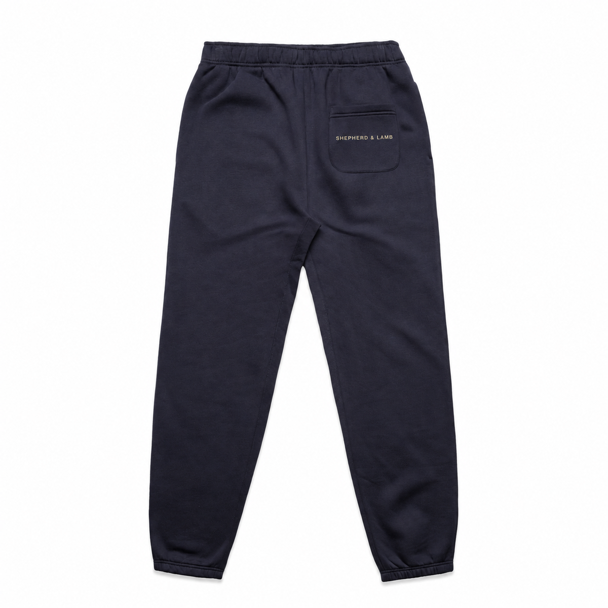 Back view of the Shepherd & Lamb Signature Relax Track Pants in Ink Blue, showing the Shepherd & Lamb wordmark on the rear pocket.