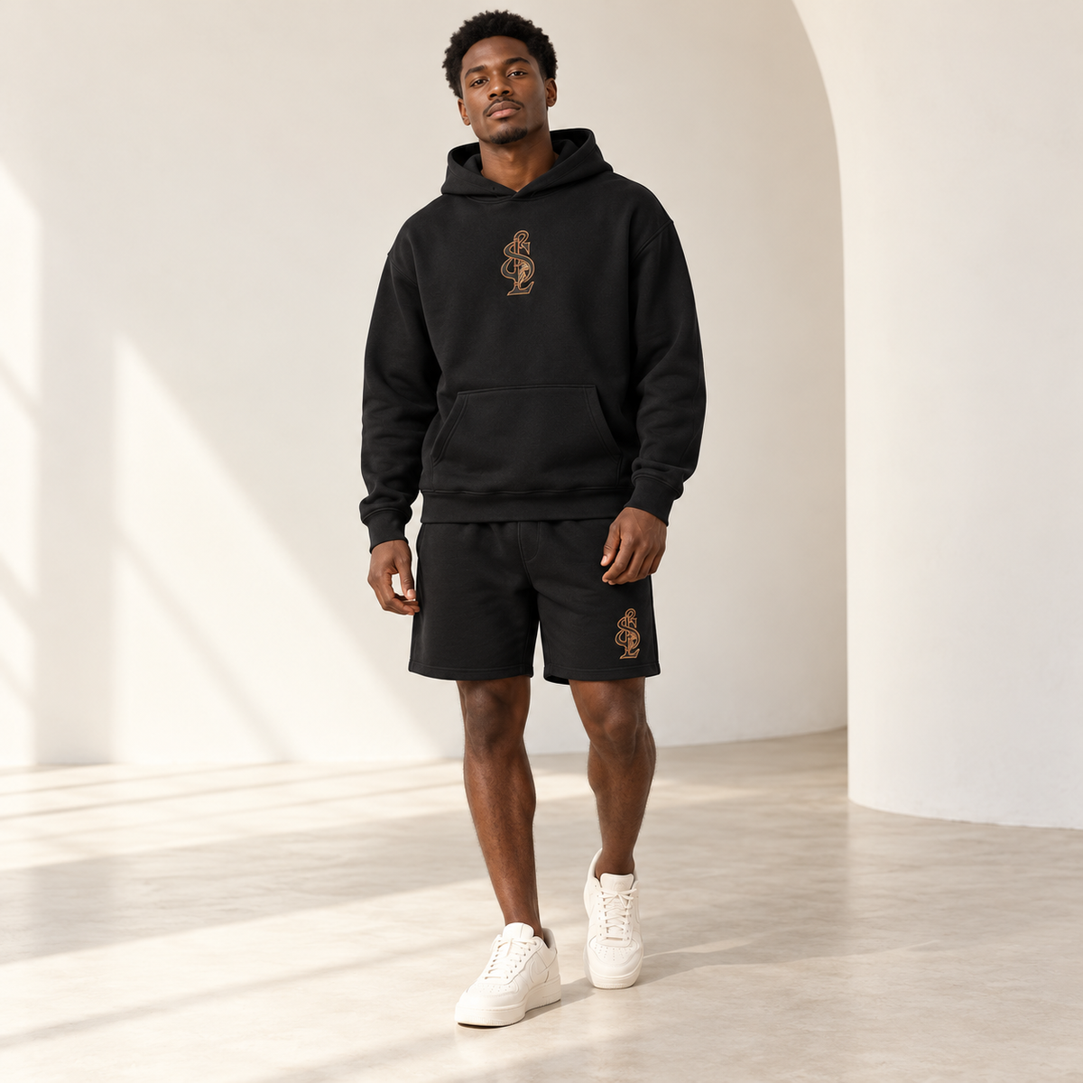 Black Signature Relax Hoodie styled with coordinating Relax Track Shorts. Pieces sold separately.