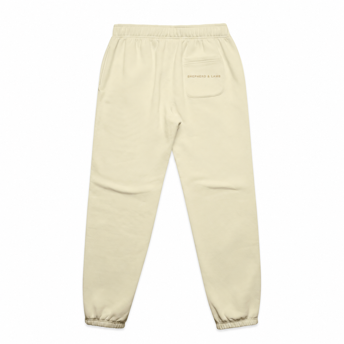 Back view of the Shepherd & Lamb Signature Relax Track Pants in Butter, showing the Shepherd & Lamb wordmark on the rear pocket.